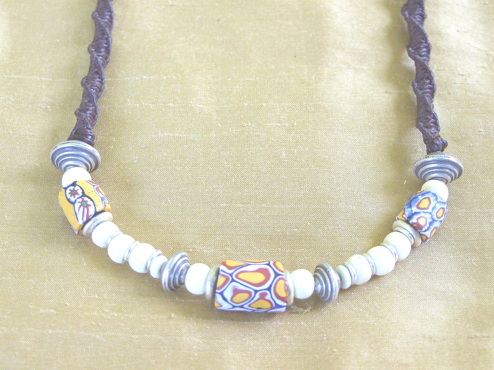 His or her trade bead necklace on a brown macrame rope